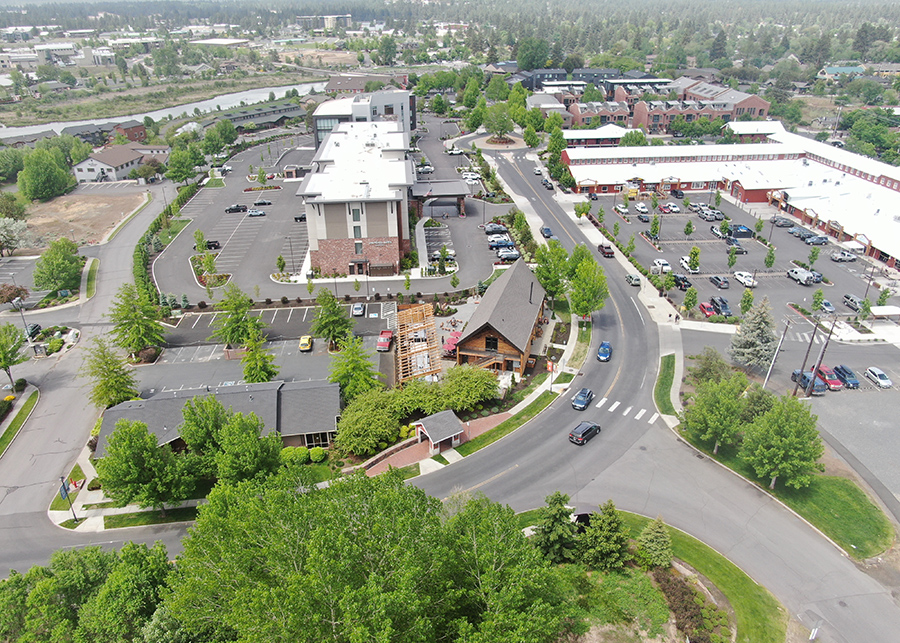 And aerial photo shows the a-frame of the crosscut taphouse and surrounding Old Mill District